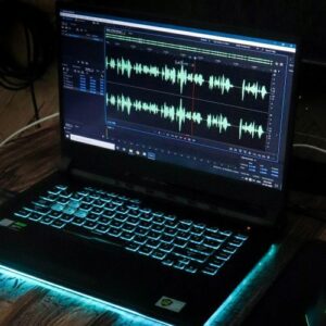 Laptop with media editing software showing sound waves.