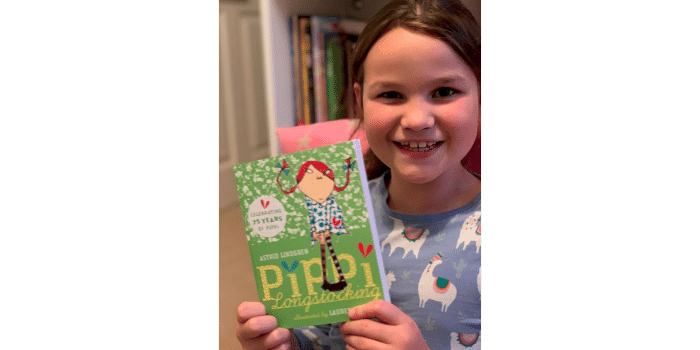  #WorldKidLitMonth | Child holding Pippi Longstocking book