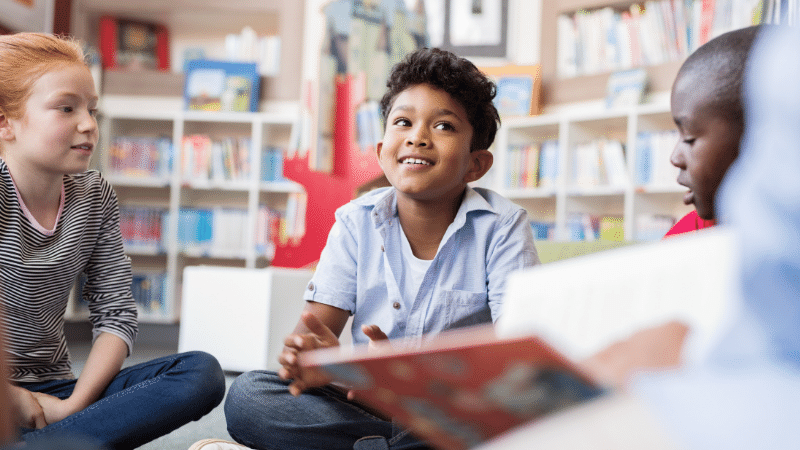  #WorldKidLitMonth | Children sat listening to stories