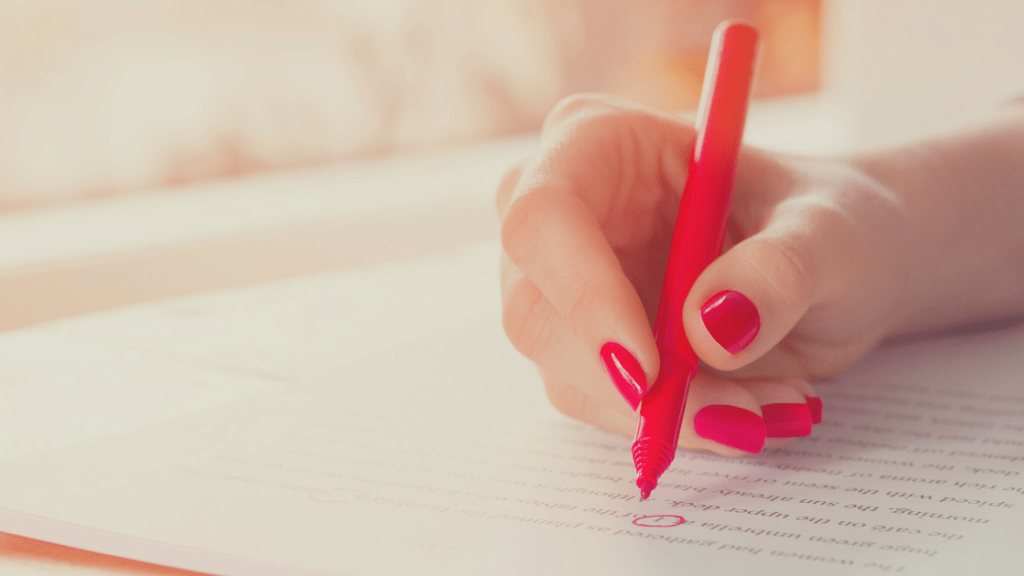 A hand editing a text to represent proofreading.