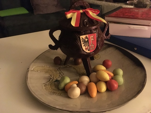 Image of chocolate cauldron with marzipan vegetables in front