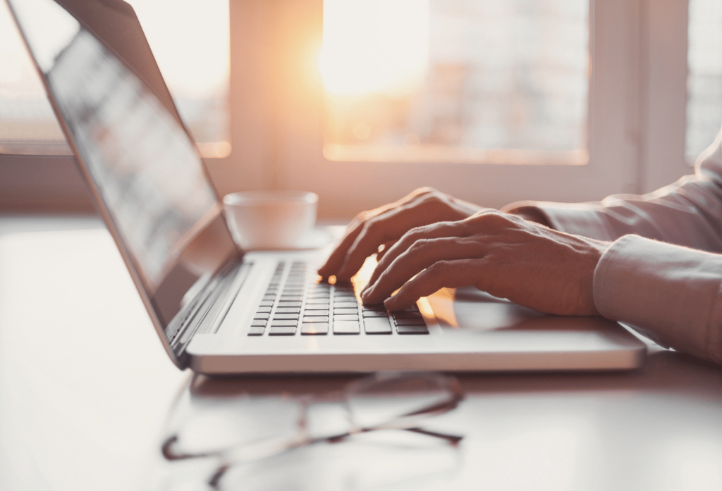 Image of hands typing on a laptop