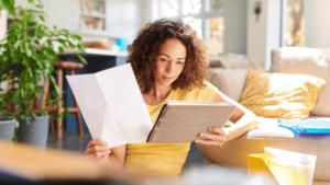 Woman reviewing documents to illustrate the finance and legal industry.